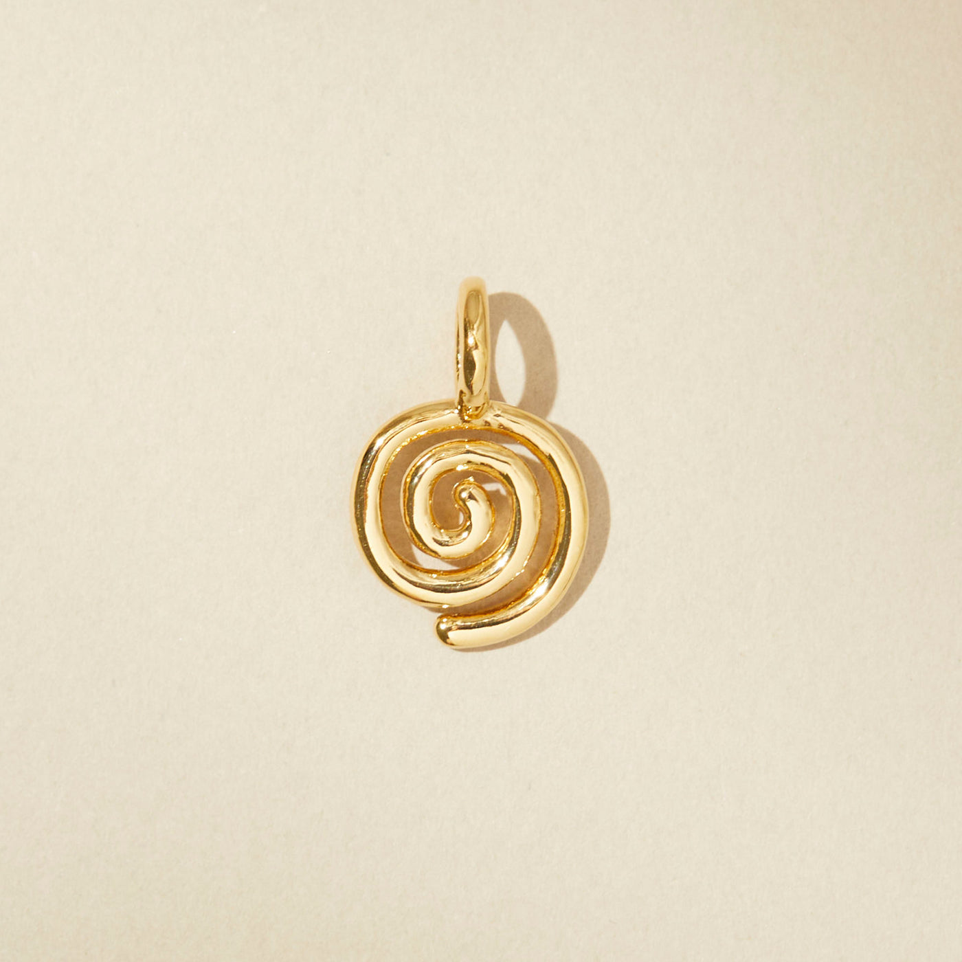 Spiral charm in gold
